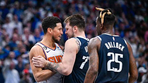 Phoenix Suns guard Devin Booker argues with Dallas Mavericks guard Luka Doncic.